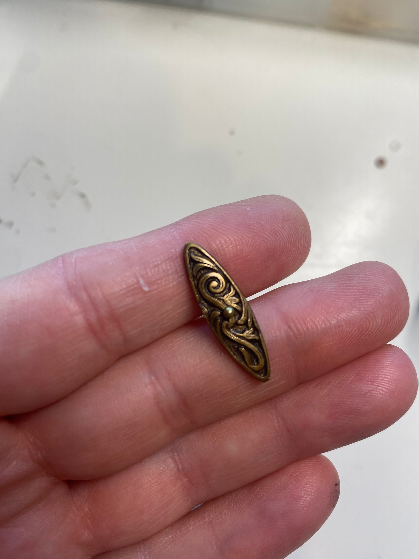 Hammered hoop and filigree toggle bar clasp. Chocolate brown bronze metal.