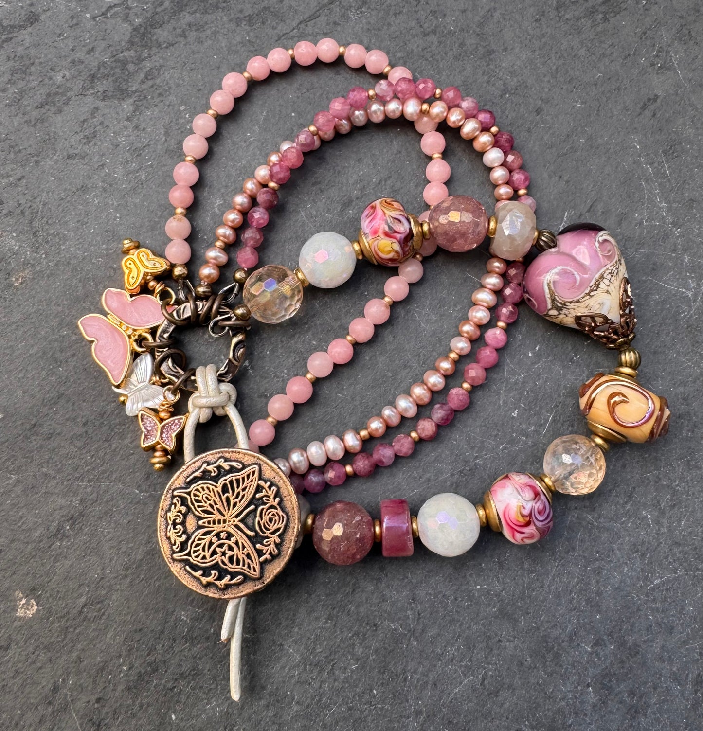 Pink opal, pink Tourmaline, moonstone mystic, strawberry quartz mystic, citrine mystic, pink pearls and handmade lamp work glass, bronze butterfly button, white leather.