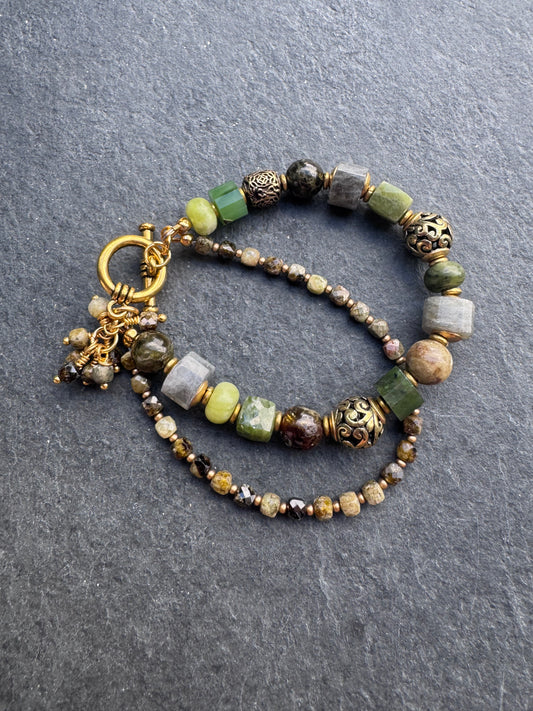 Green garnet, labradorite, jade, and gold metal bracelet.