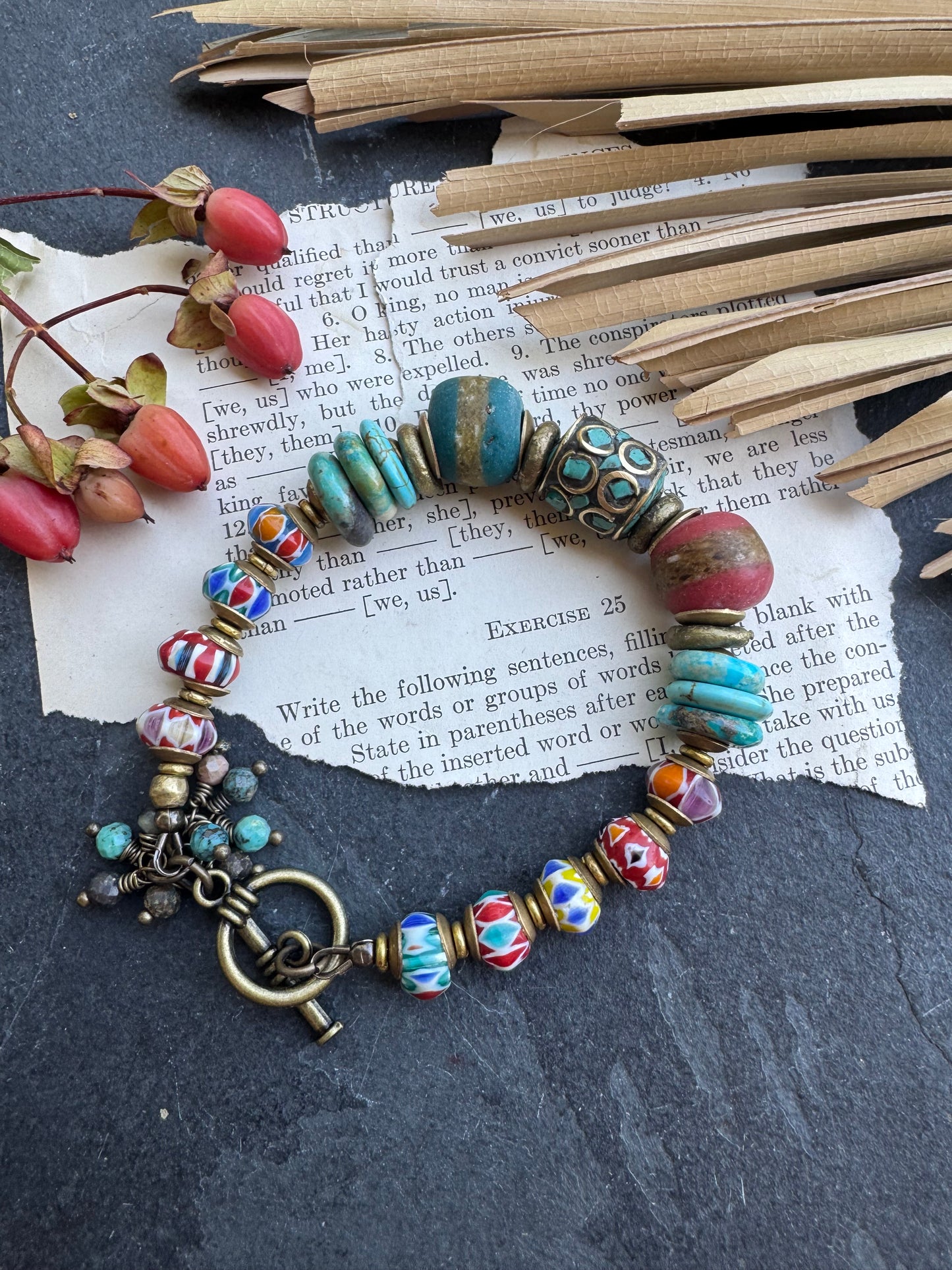 Turquoise stone, nepal glass, African glass, brass metal, bracelet. Czech Button and leather closure.
