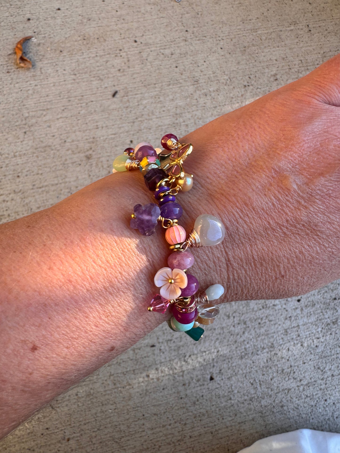 Flower mixed charm bracelet. Mixed stones, pearls and charms, gold metal bracelet.