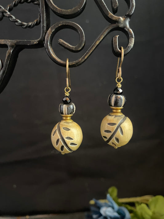 Wood leaf beads, black onyx stone, and bronze metal earrings.