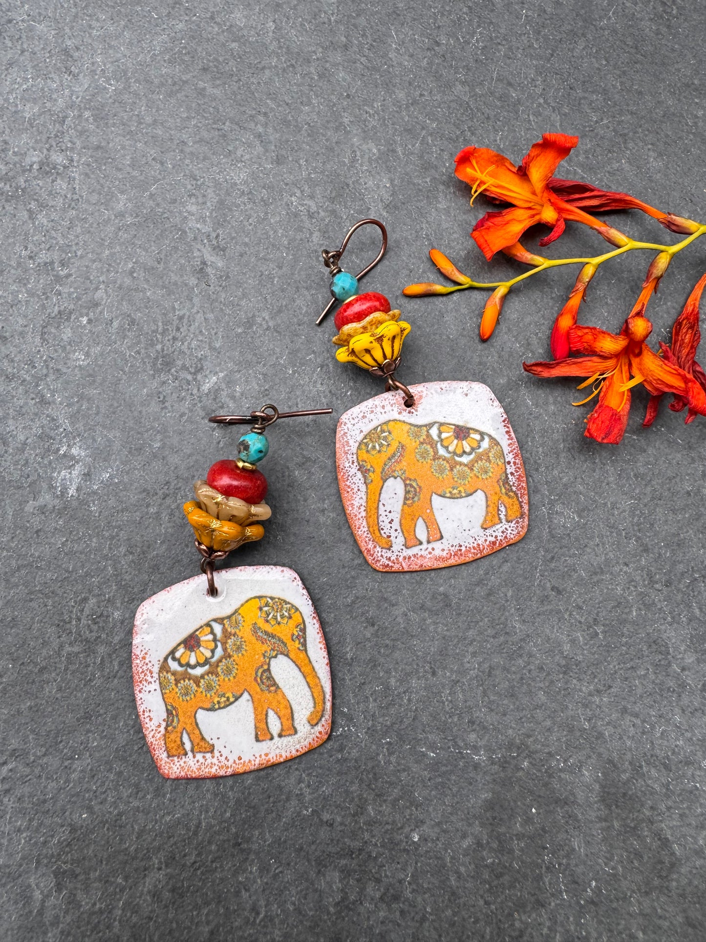 Elephant enameled metal charms, glass flower beads, red coral, turquoise and copper metal, earrings