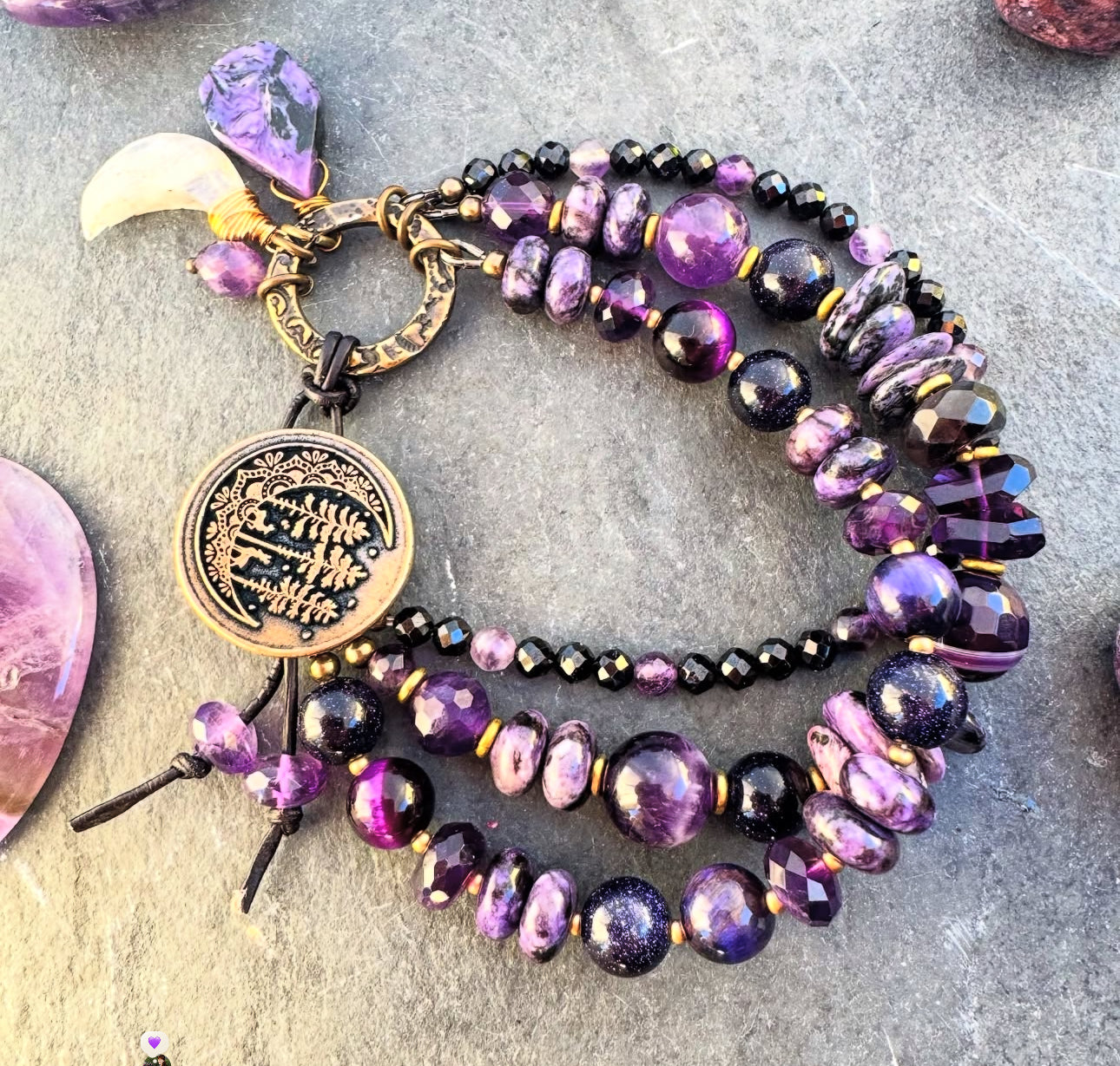 amethyst, Onyx, purple goldstone, Charoite and purple tigers eye. Button detailed clasp.