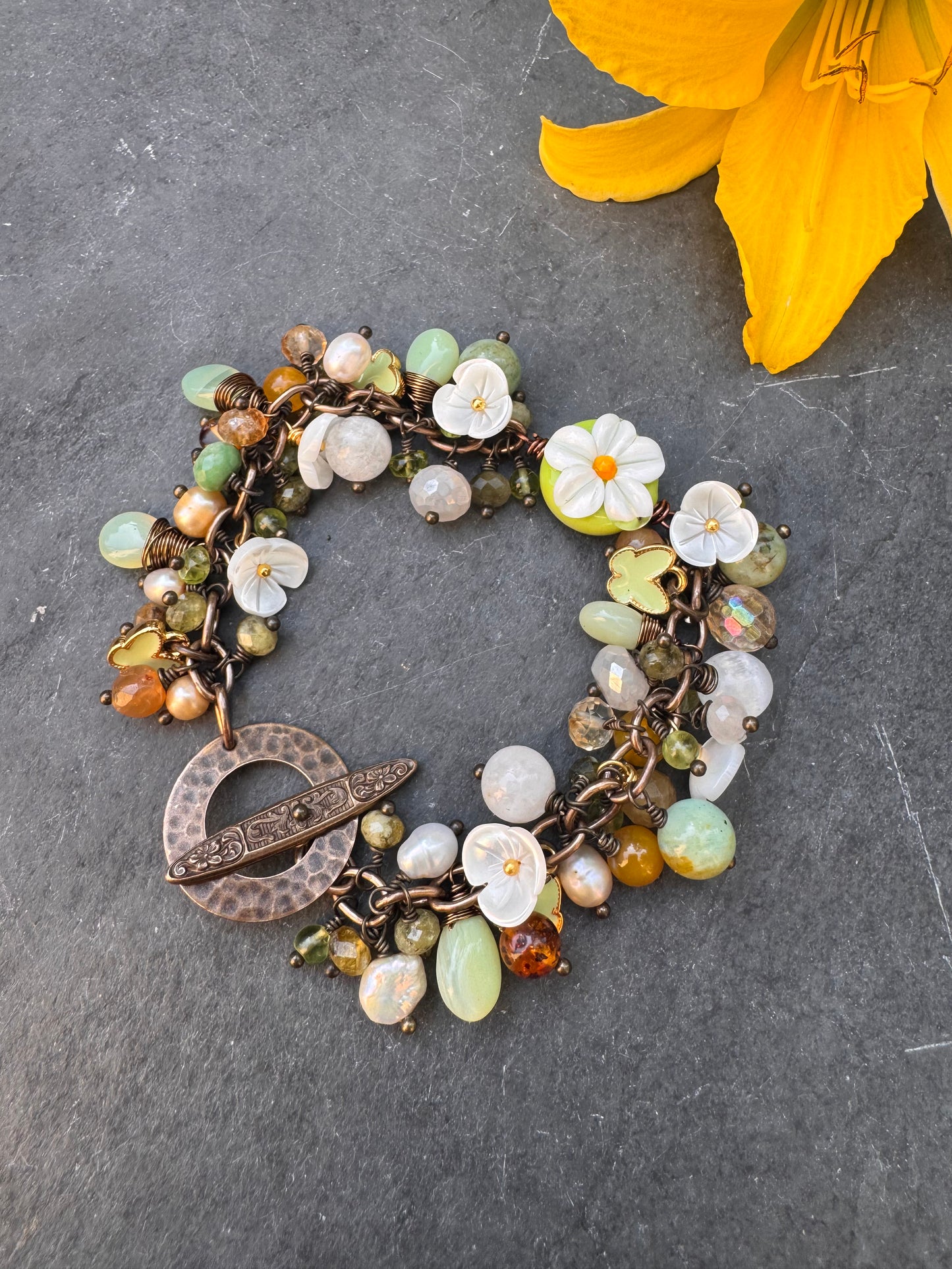 Daisy. Handmade lampwork glass, Mixed gemstone, pearls, bronze metal, charm bracelet.