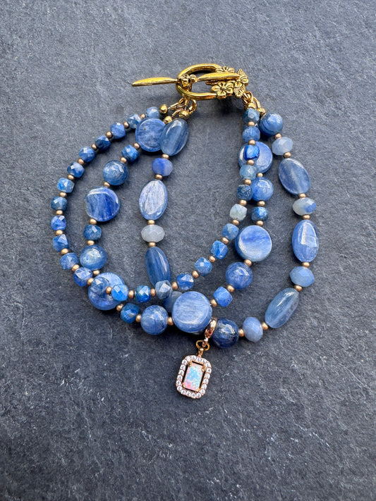 Kyanite gemstone and gold metal bracelet.