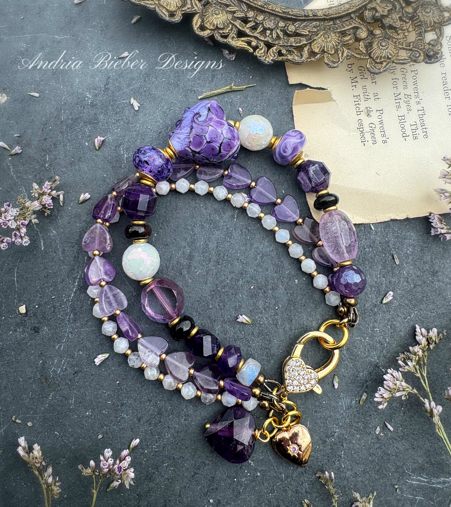 Purples. Mixed gemstone, lampwork glass, rhinestone clasp.