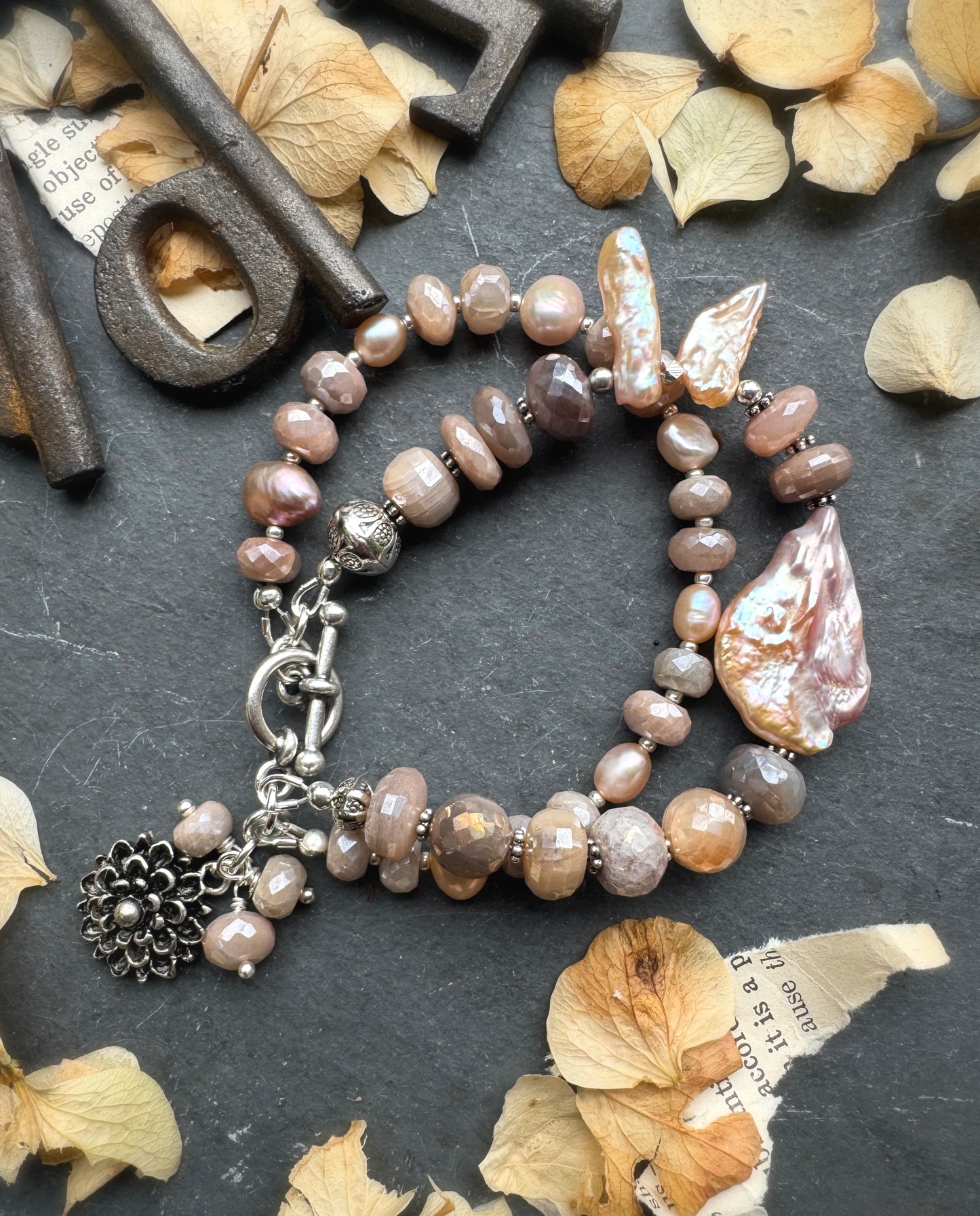 Peach moonstone, petal pink pearls, sterling and silver metal.