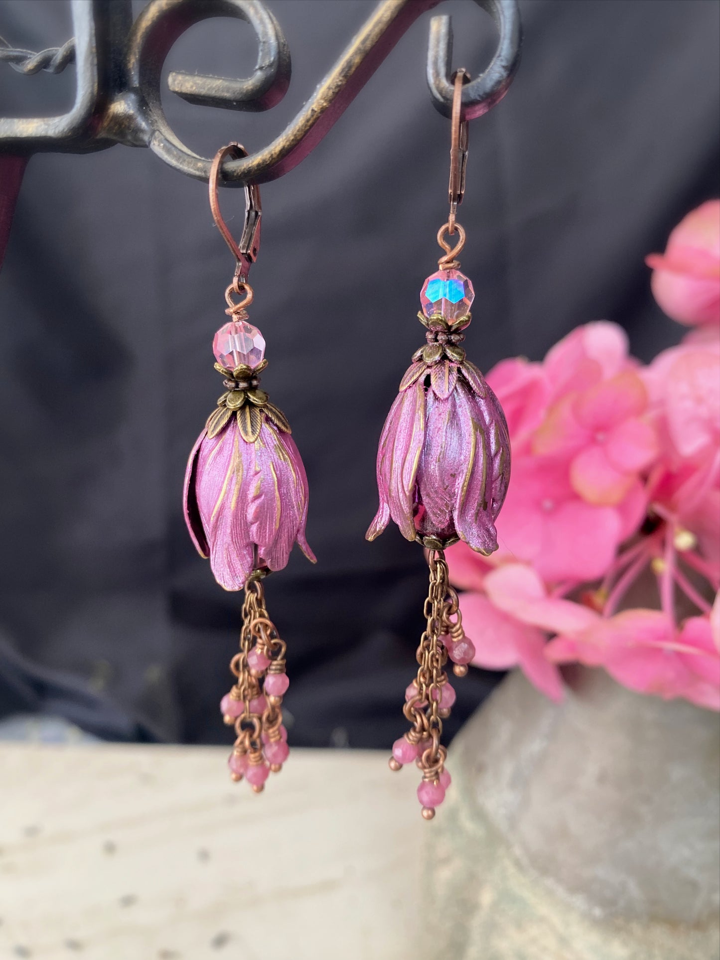 Pink crystal glass, pink tourmaline stone, flower bead caps, and copper metal earrings.