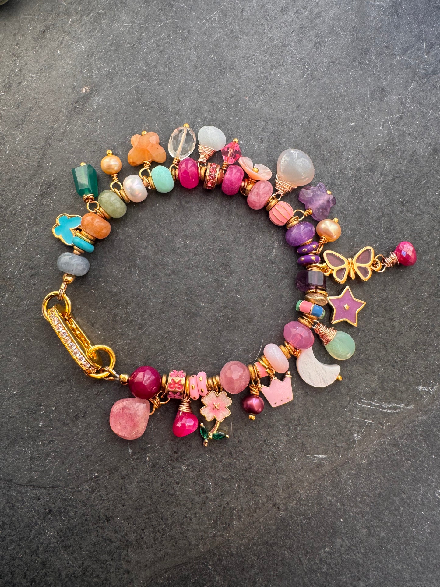 Flower mixed charm bracelet. Mixed stones, pearls and charms, gold metal bracelet.