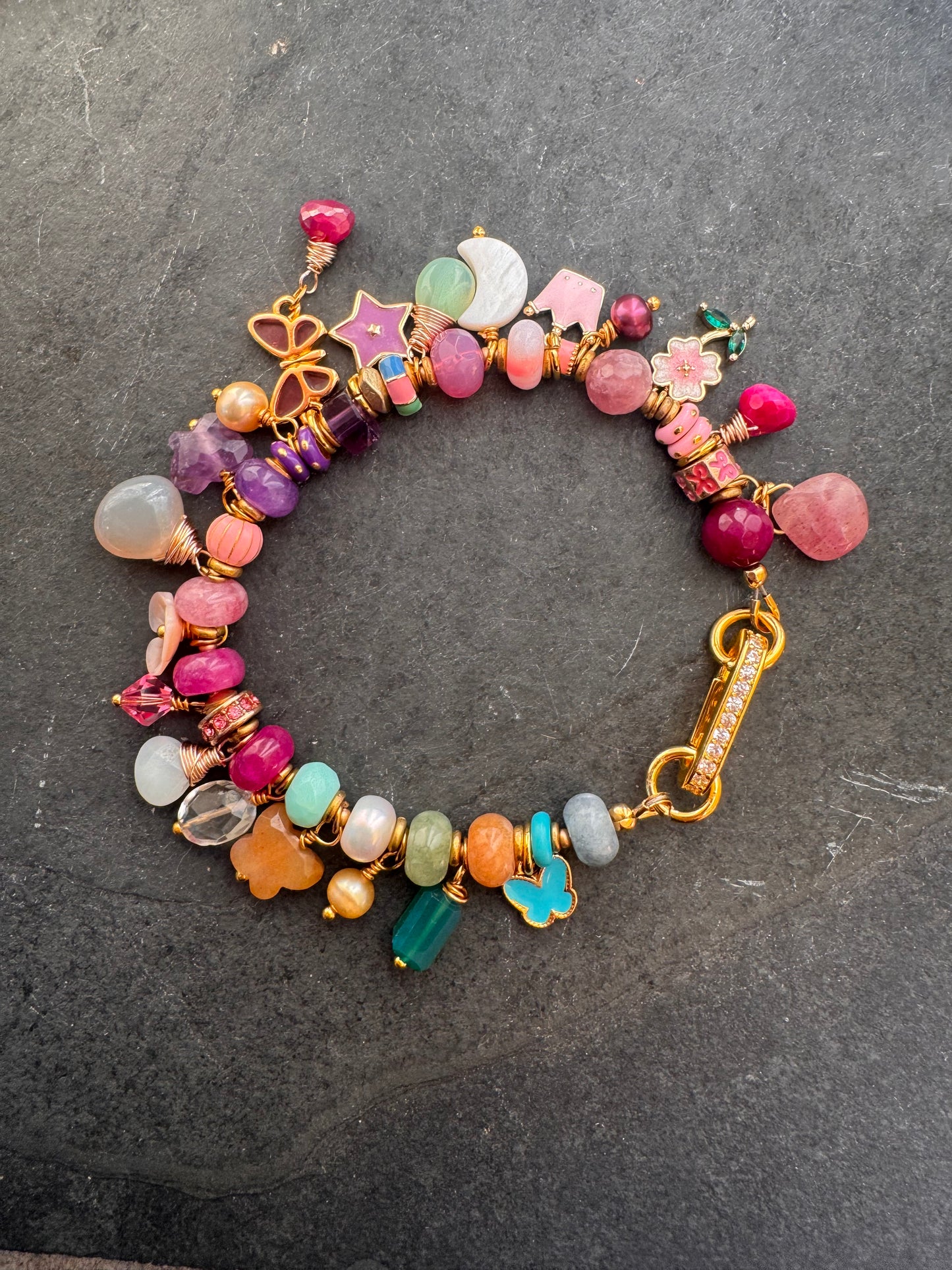 Flower mixed charm bracelet. Mixed stones, pearls and charms, gold metal bracelet.