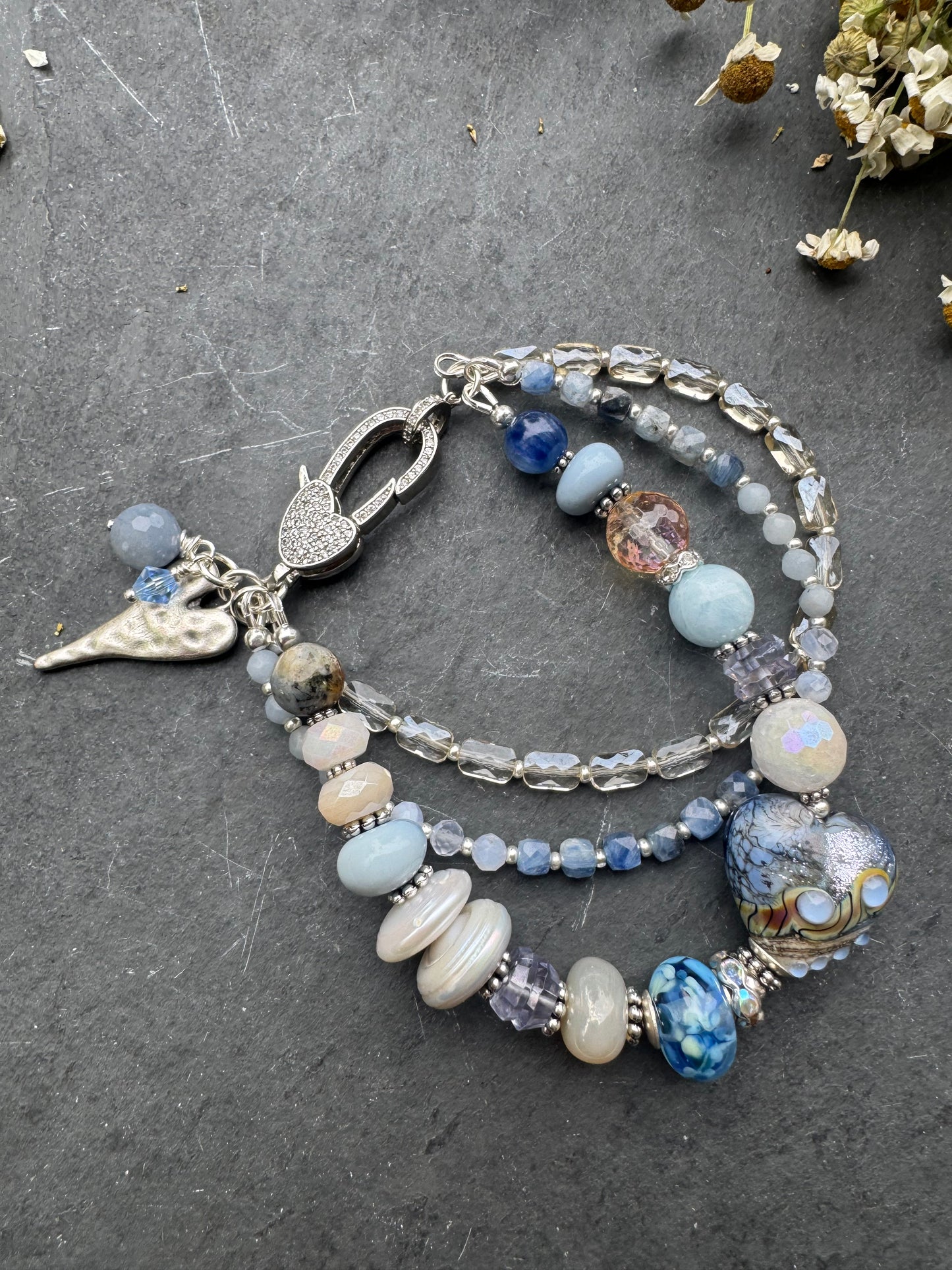 Lamp work glass, blue opal, blue kyanite, mystic moonstone, mystic citrine, pearls, iolite, aquamarine, crazy lace blue agate, blue aventurine stone, silver metal, rhinestone clasp, bracelet