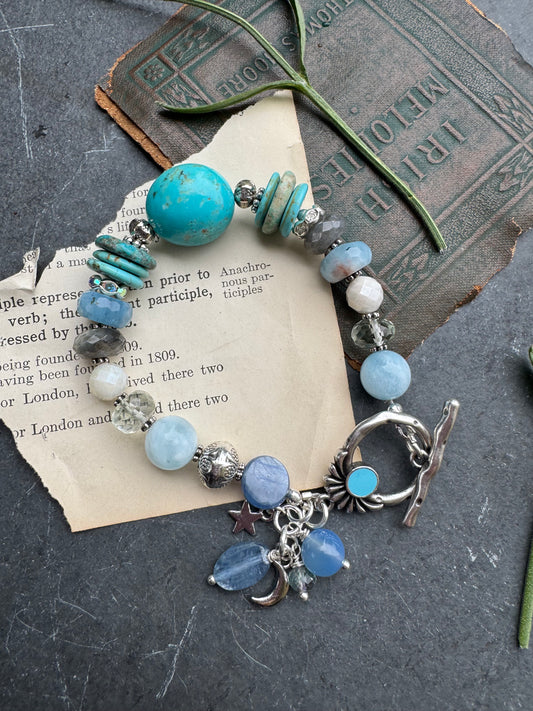 Turquoise stone, aquamarine, kyanite, green amethyst, labradorite, silver metal.