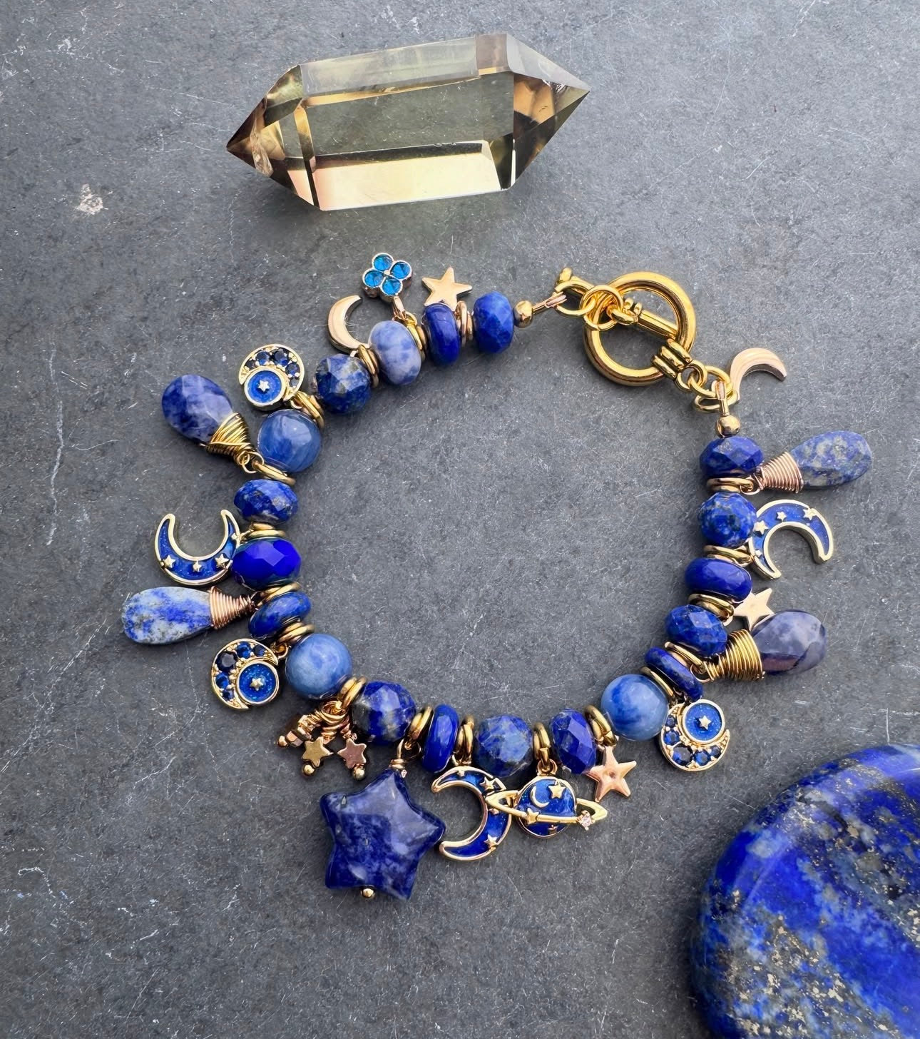 Space charm bracelet. Lapis lazuli, sodalite, charms and gold metal bracelet.