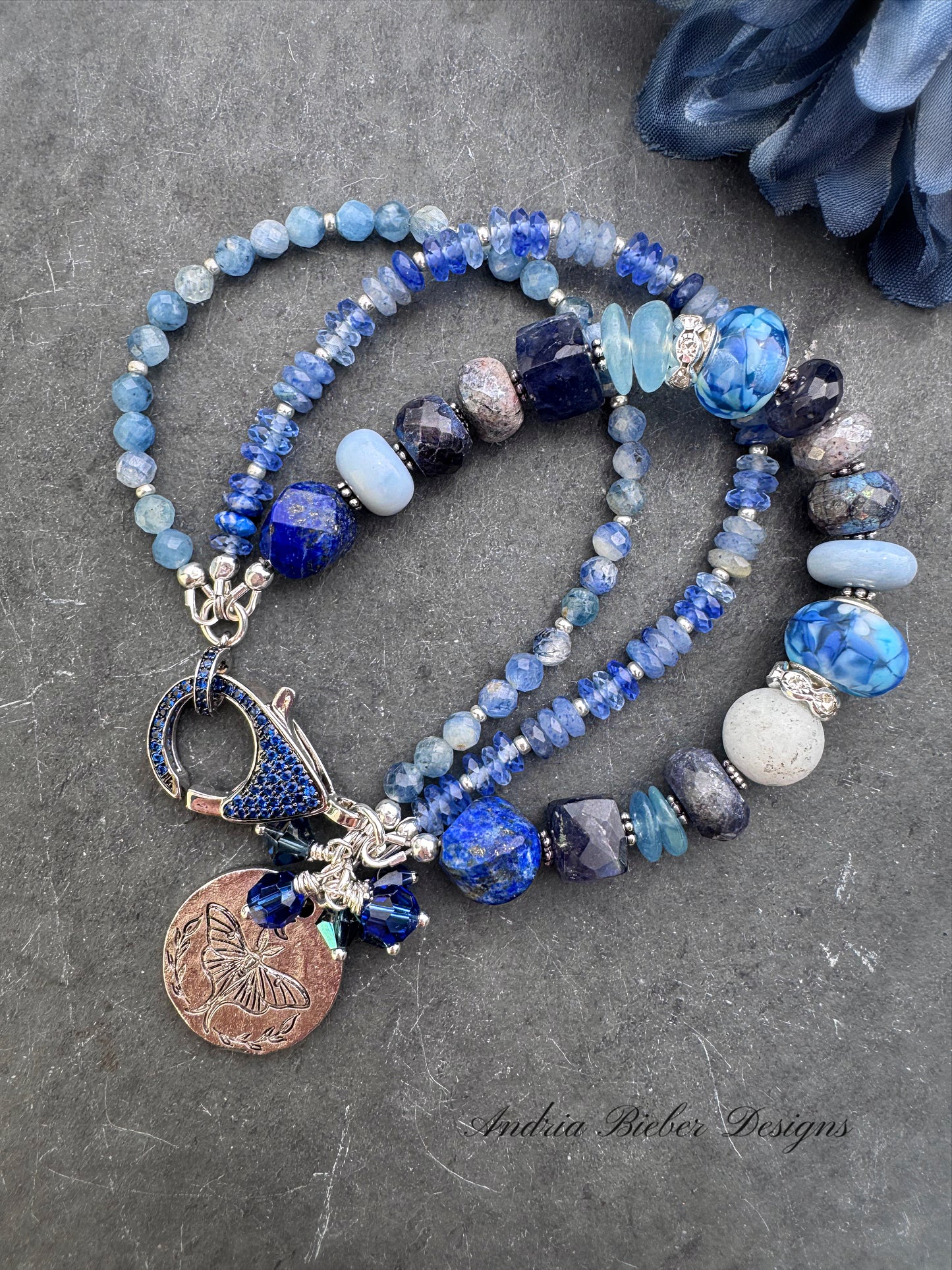 lapis lazuli, isolate, aquamarine, kyanite, Sky Blue Agate, sodalite, handmade lampwork glass, and silver metal Rhinestone clasp in deep blue crystals.