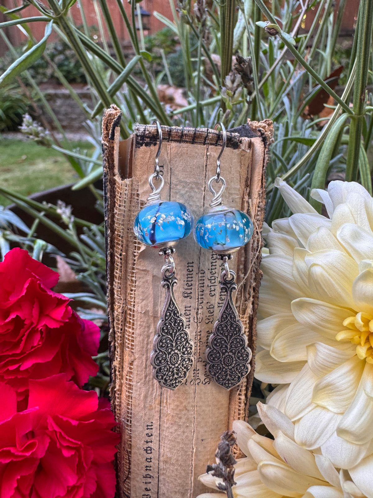 Handmade lampwork glass in blue and black, silver filigree drop, earrings.