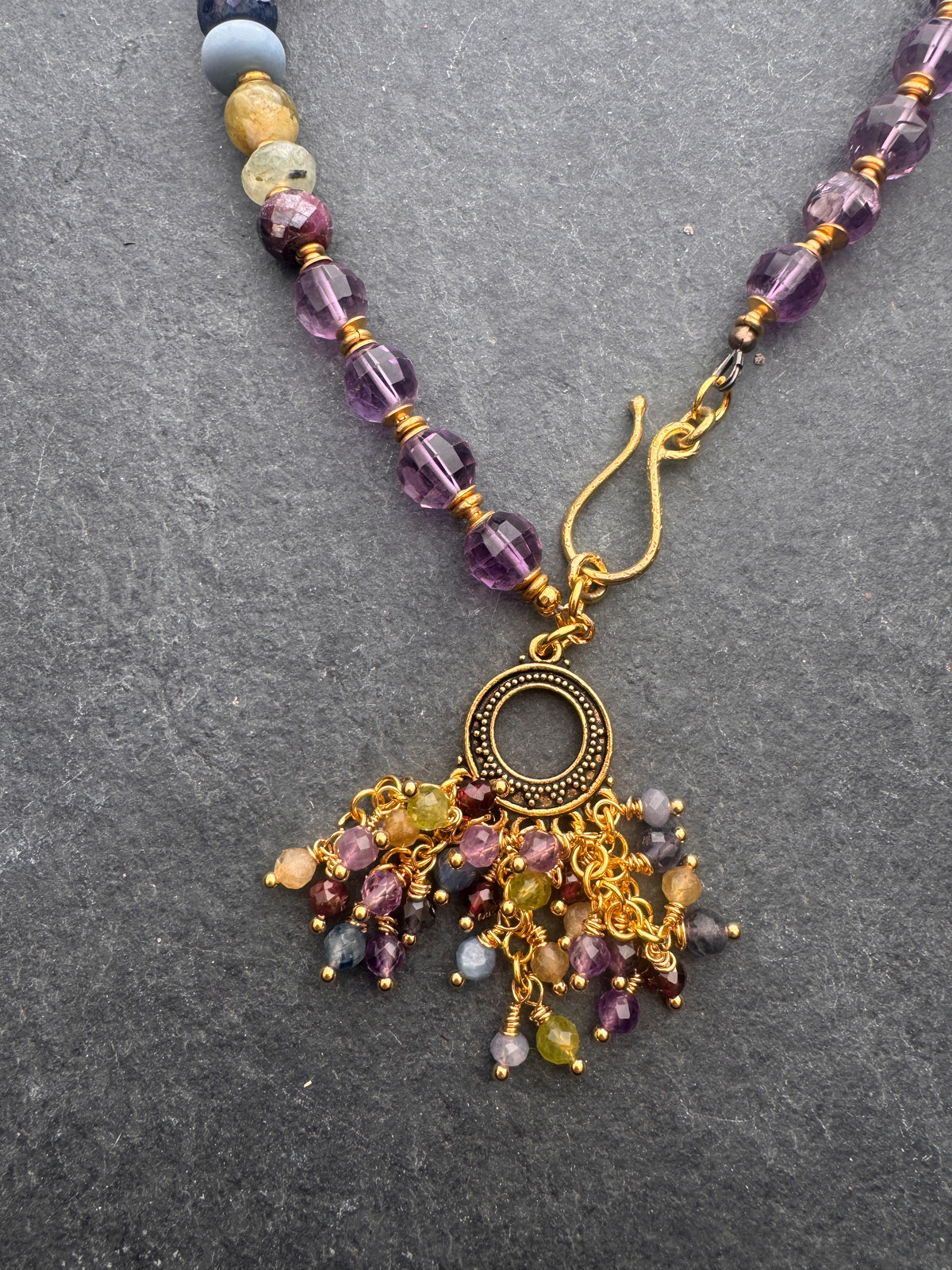 Amethyst faceted gemstone, iolite, green garnet, garnet, prehnite, peridot, aquamarine, blue opal and brass metal, necklace.