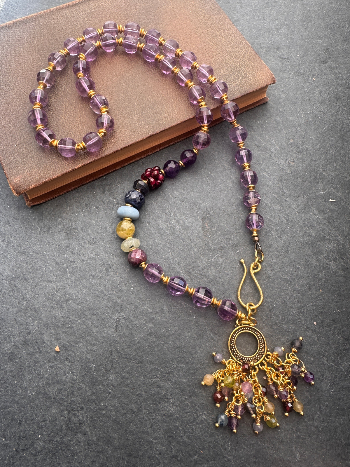 Amethyst faceted gemstone, iolite, green garnet, garnet, prehnite, peridot, aquamarine, blue opal and brass metal, necklace.