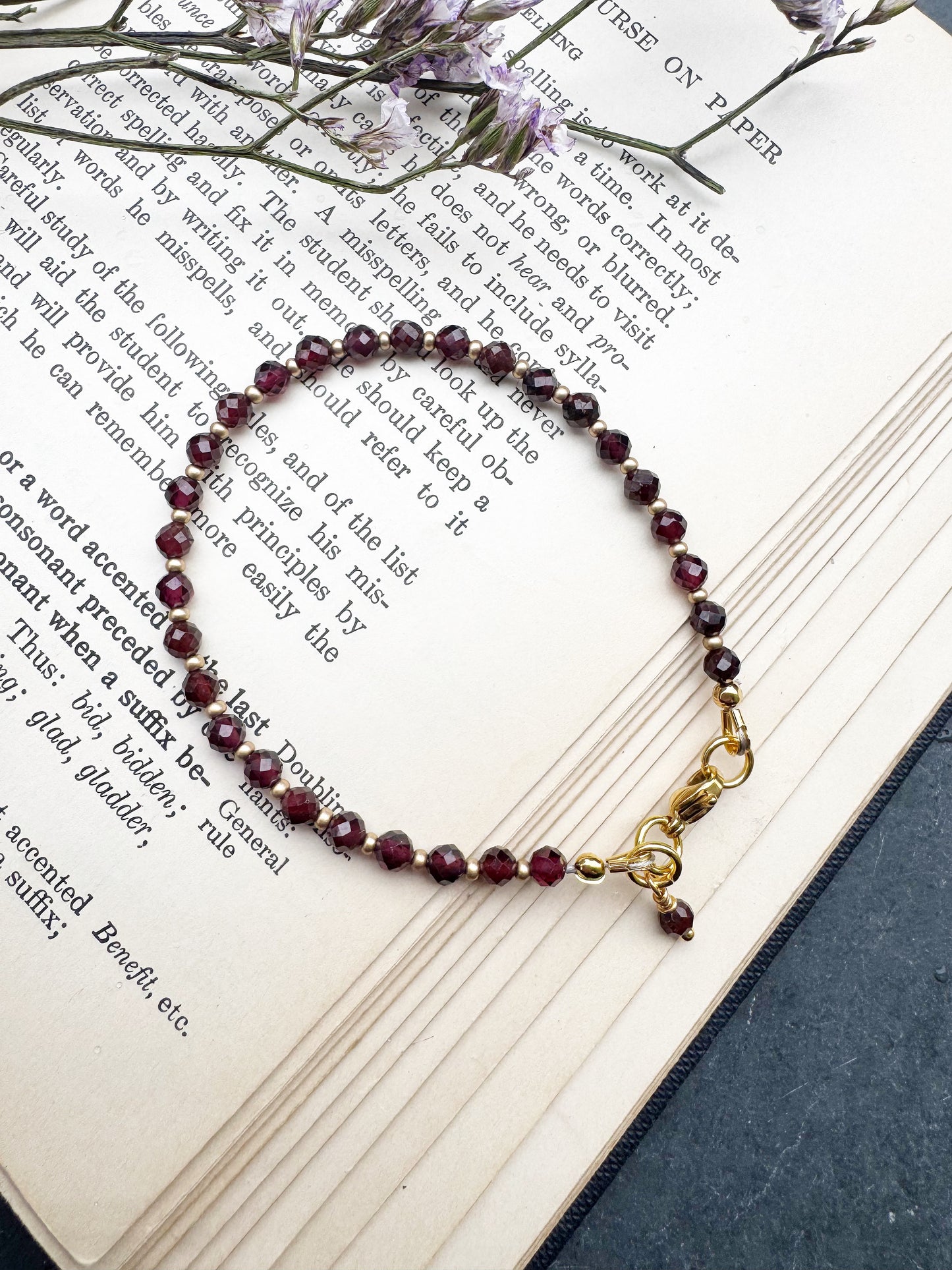 Garnet (January birthstone) faceted round stone, gold metal, bracelet