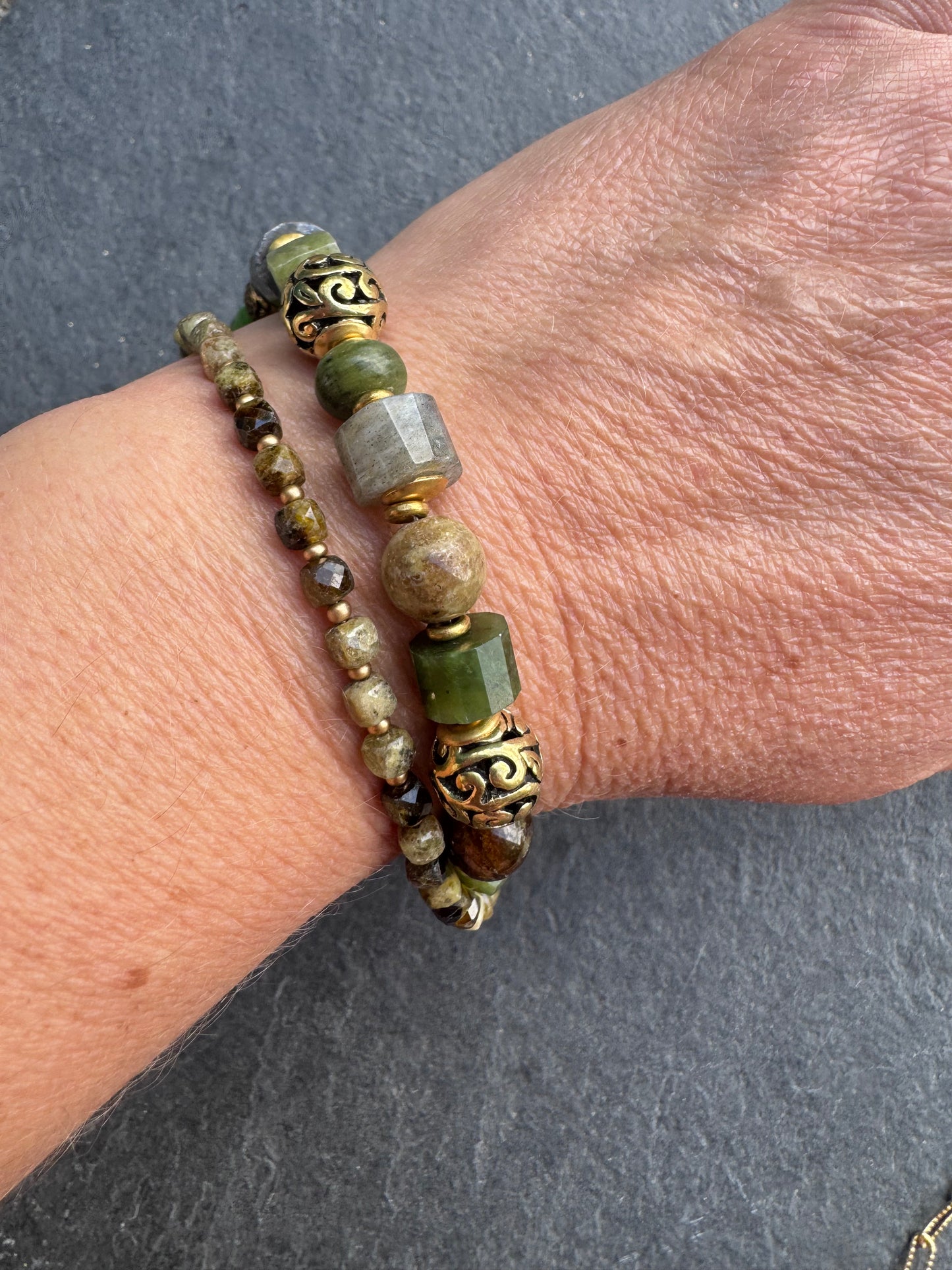 Green garnet, labradorite, jade, and gold metal bracelet.