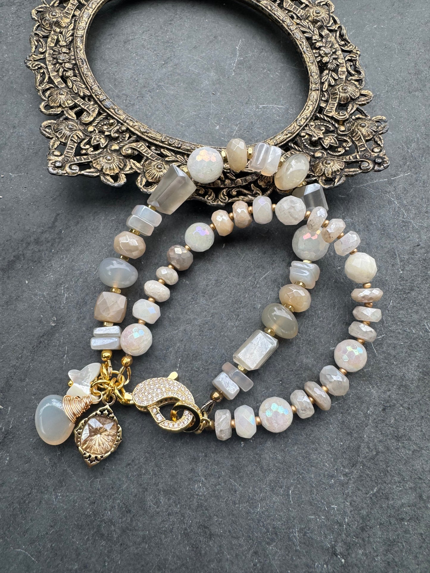Moonstone, rhinestone clasp, two multi strand, gold metal, bracelet.