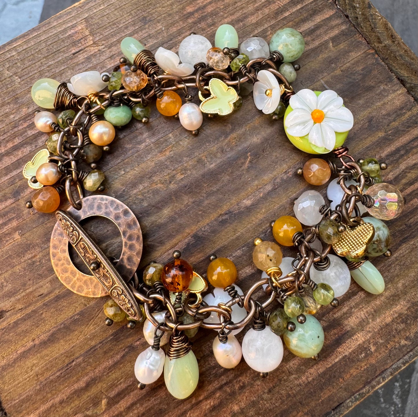 Daisy. Handmade lampwork glass, Mixed gemstone, pearls, bronze metal, charm bracelet.