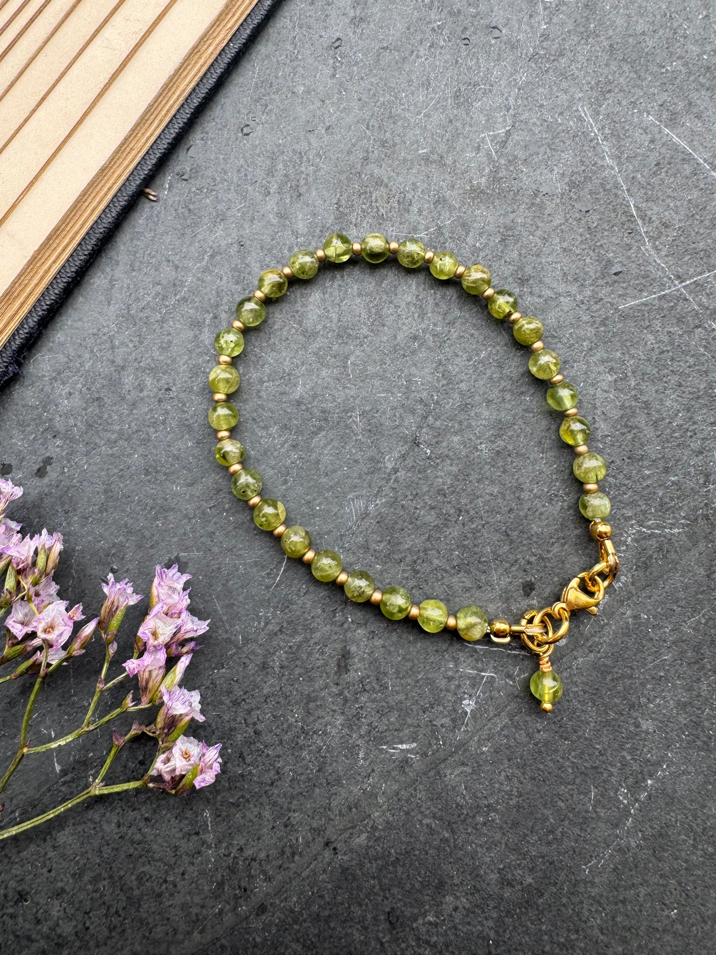 Peridot (August birthstone) round stone, gold metal, bracelet