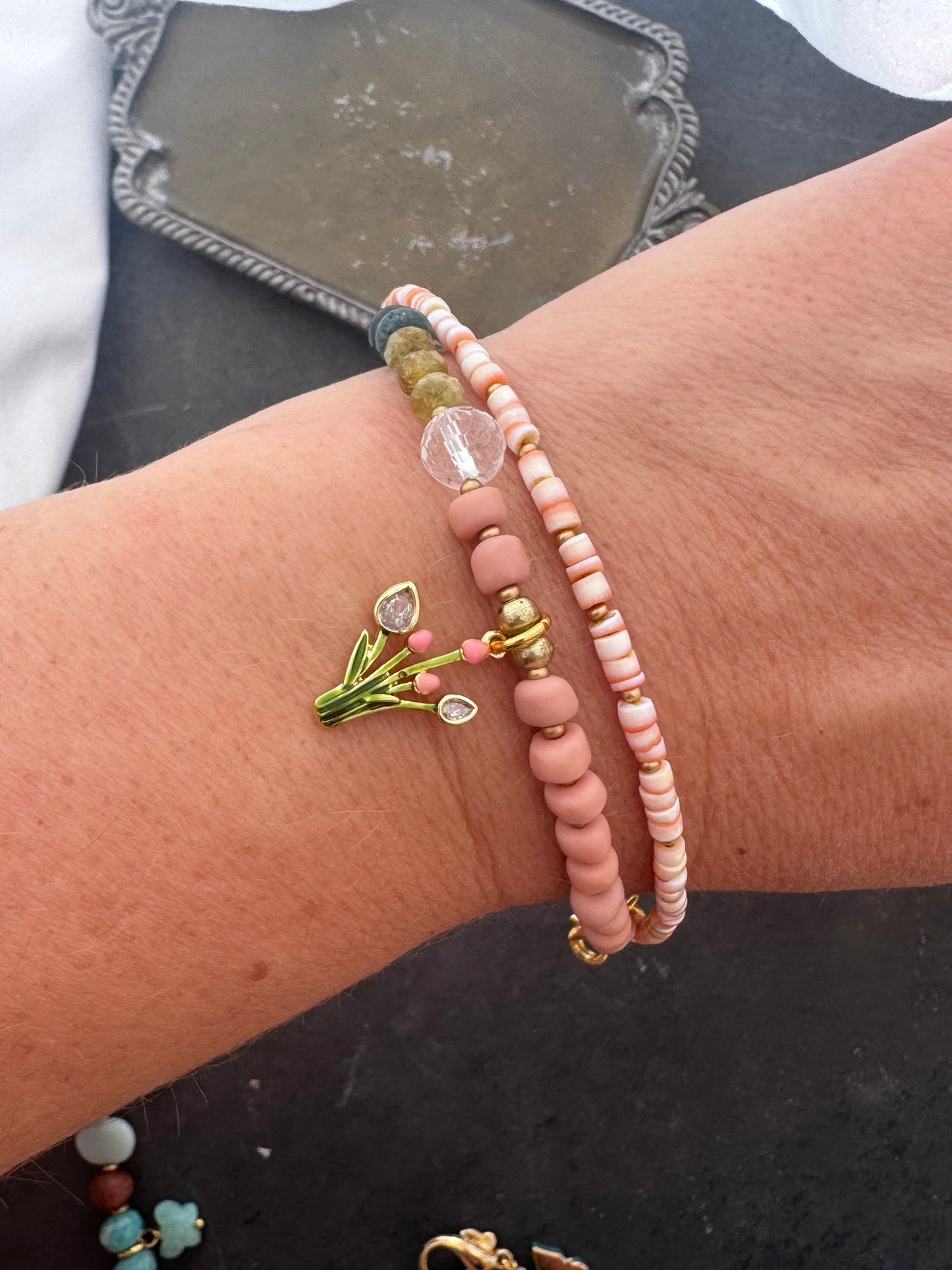 Pink shell, Java glass, quartz, peridot stone, gold metal bracelet.