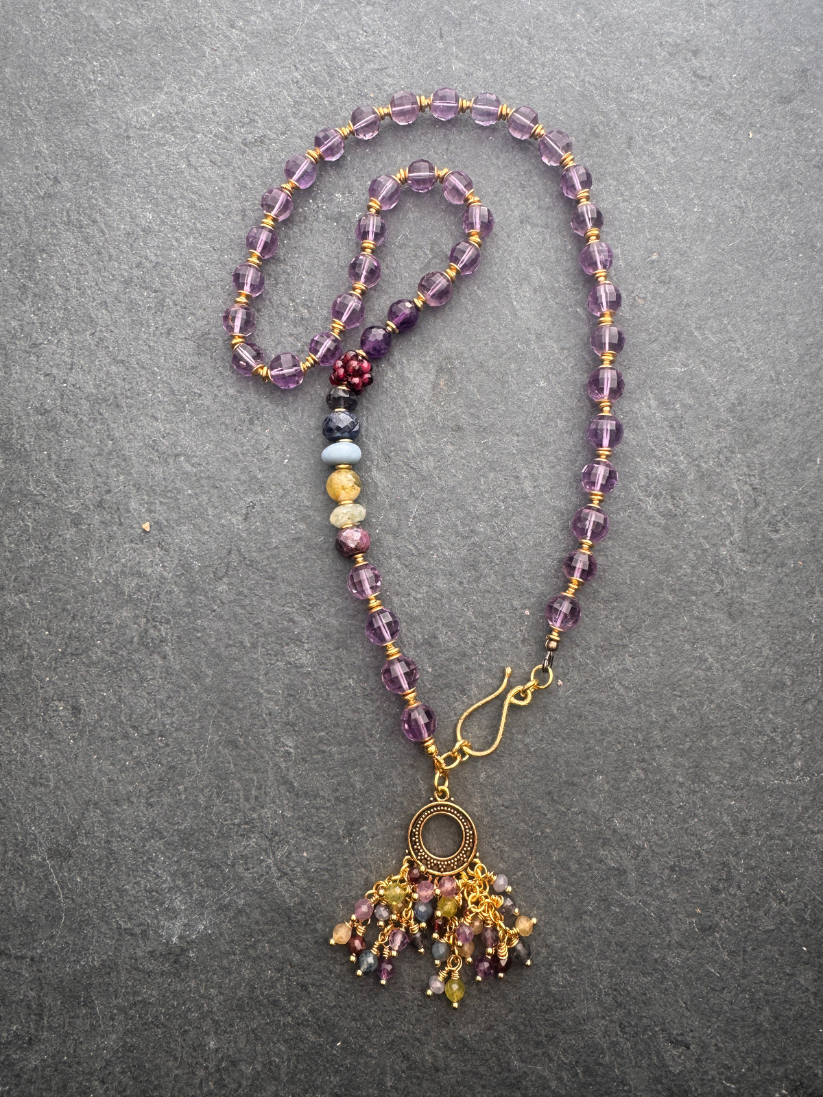 Amethyst faceted gemstone, iolite, green garnet, garnet, prehnite, peridot, aquamarine, blue opal and brass metal, necklace.