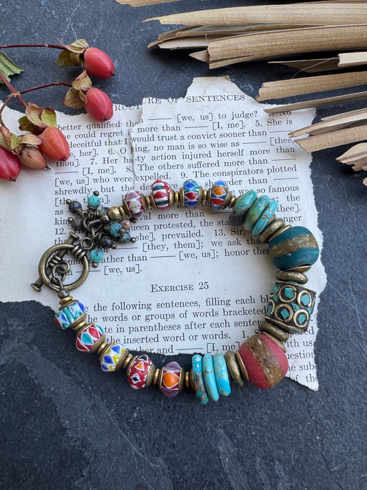 Turquoise stone, nepal glass, African glass, brass metal, bracelet. Czech Button and leather closure.