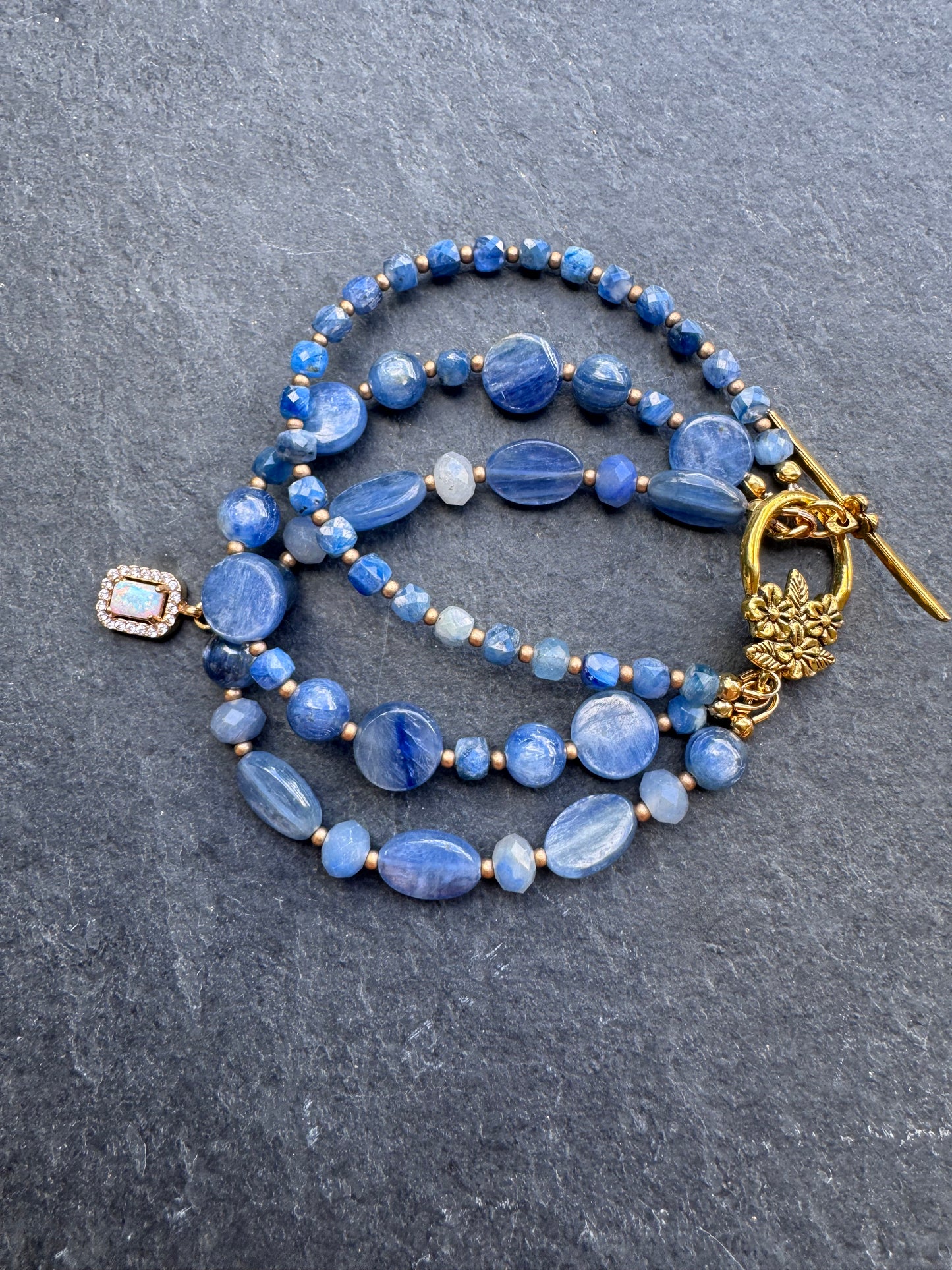 Kyanite gemstone and gold metal bracelet.