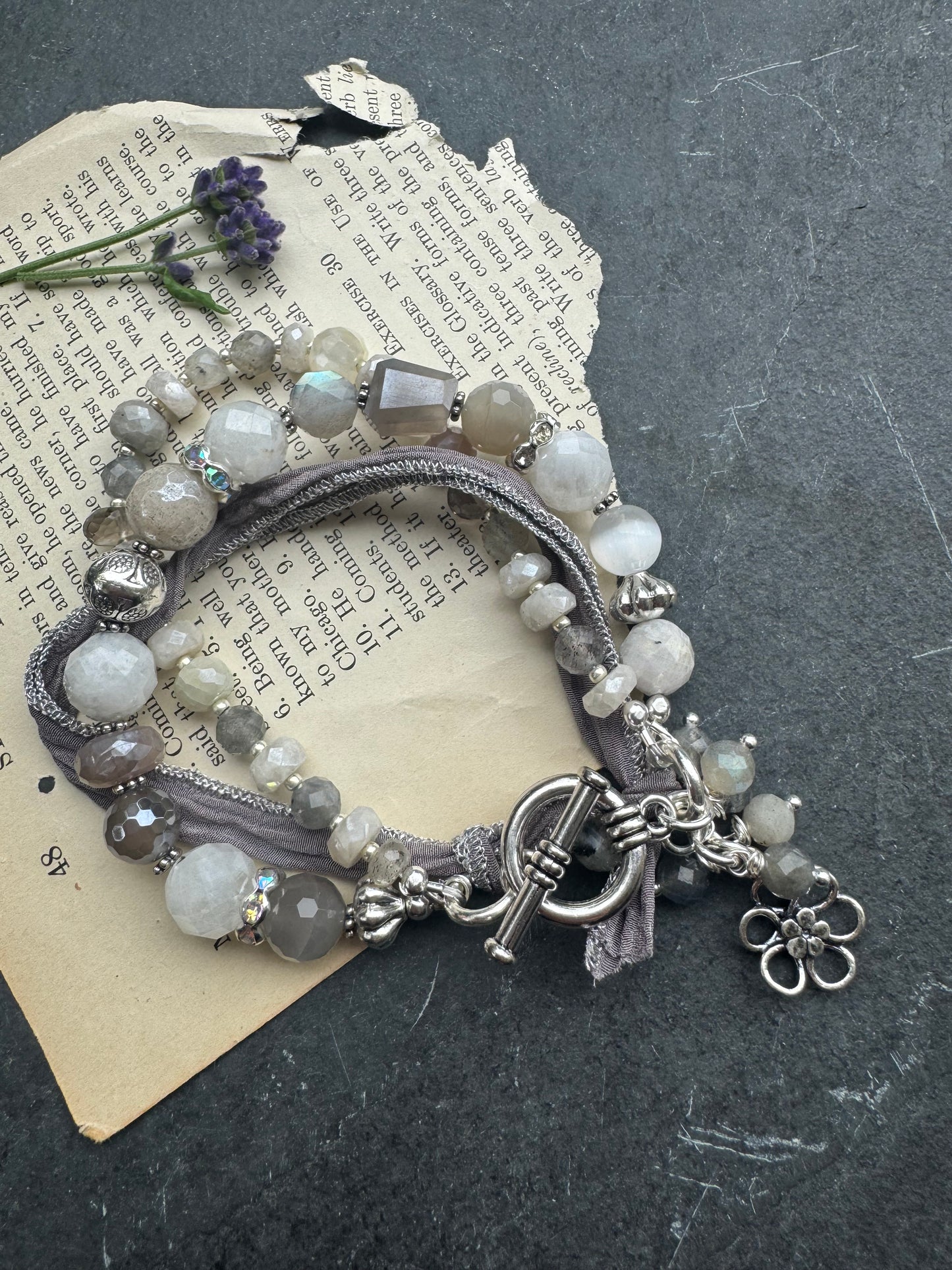White & grey  moonstone, silver silk ribbon, and sterling silver metal.