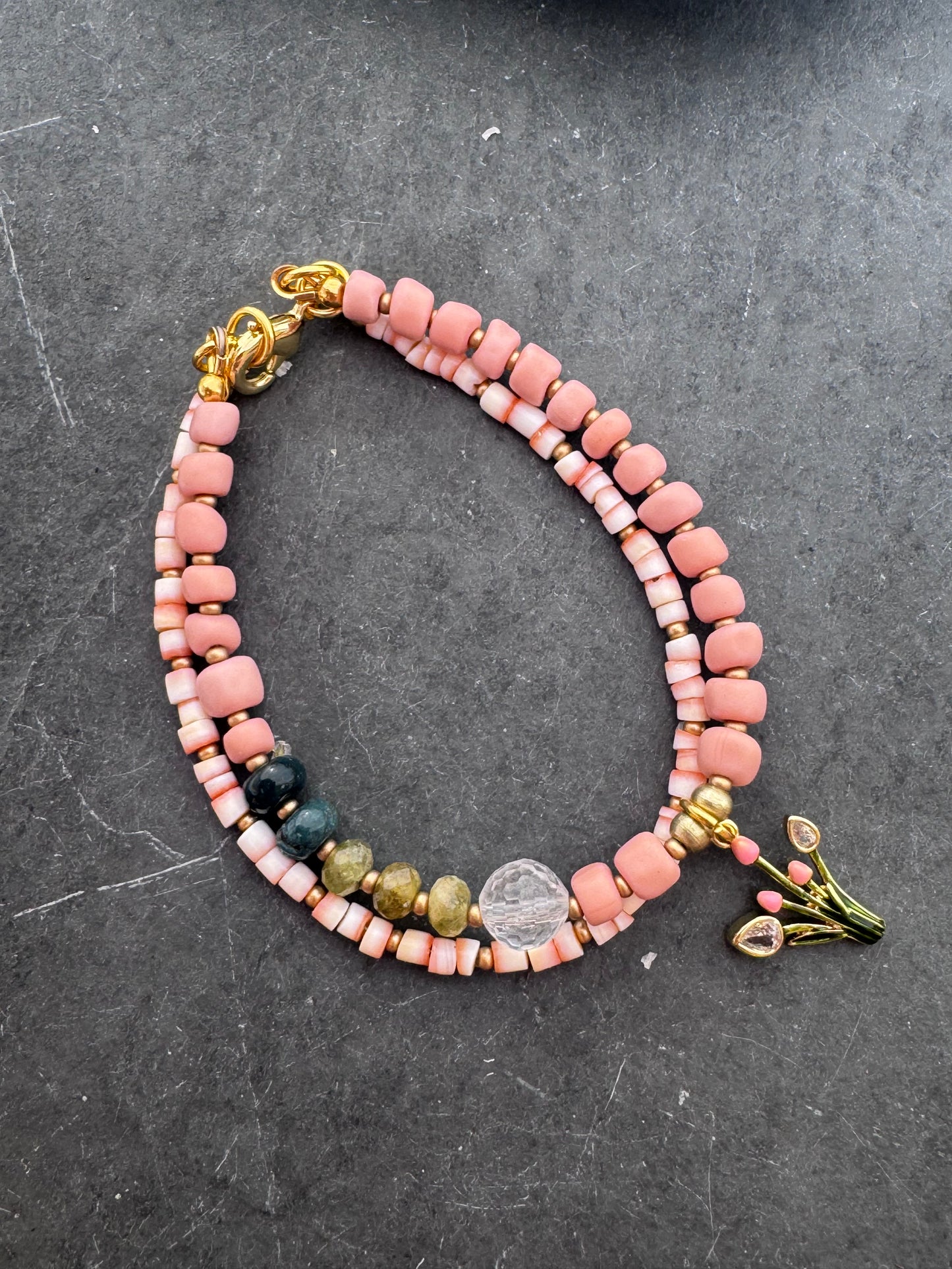 Pink shell, Java glass, quartz, peridot stone, gold metal bracelet.