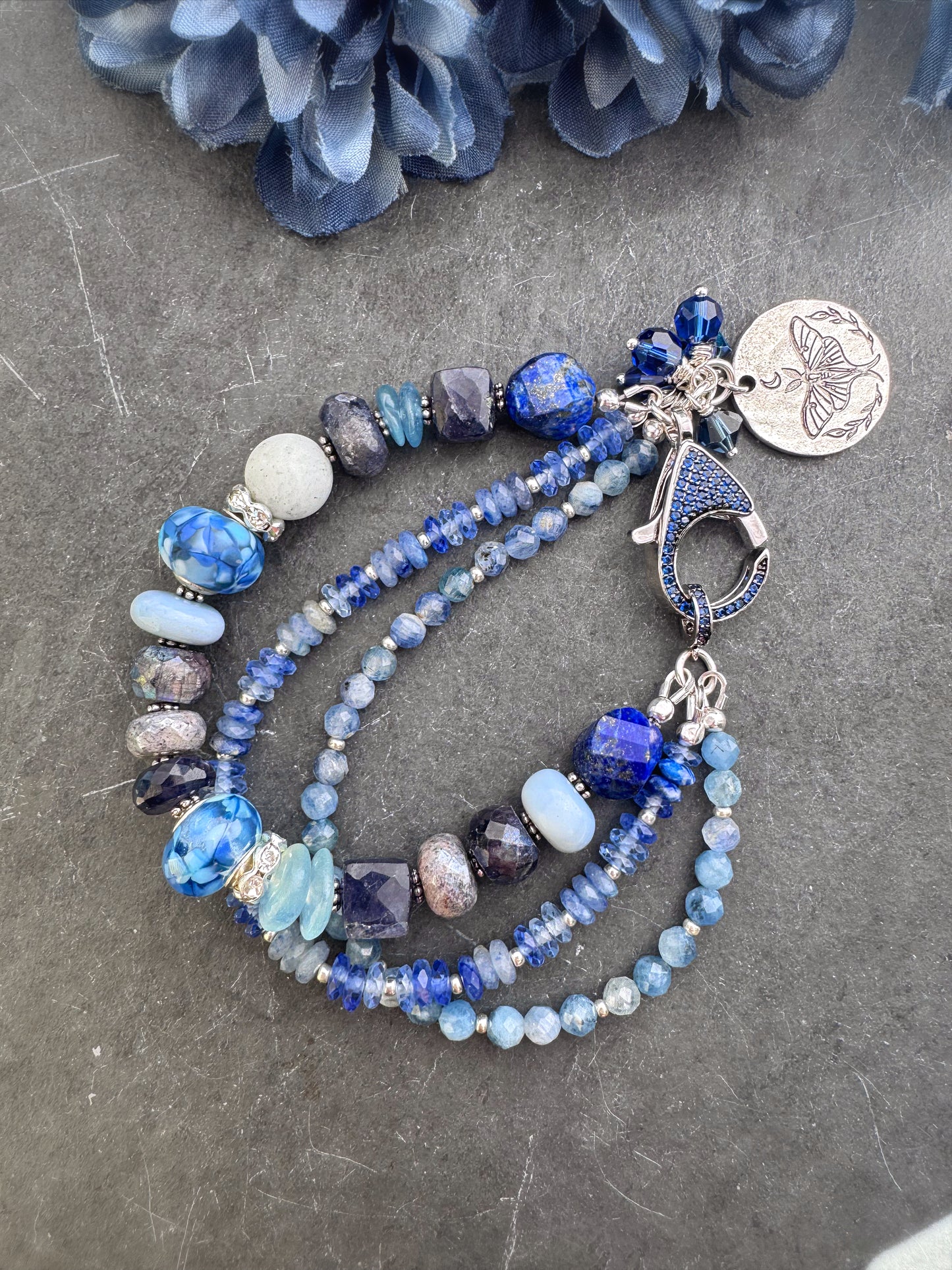 lapis lazuli, isolate, aquamarine, kyanite, Sky Blue Agate, sodalite, handmade lampwork glass, and silver metal Rhinestone clasp in deep blue crystals.