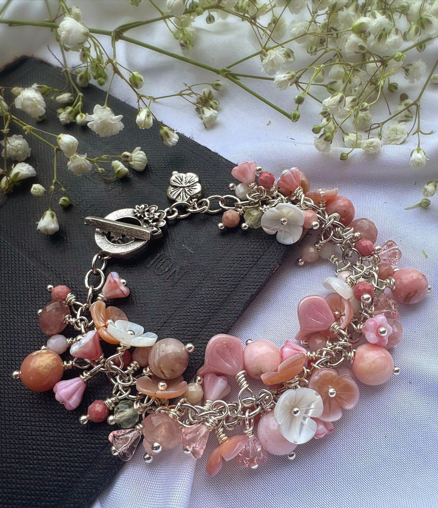 Pink opal, pink shell blossoms, rose quartz, peridot, sterling silver metal, blossom clasp, bracelet.