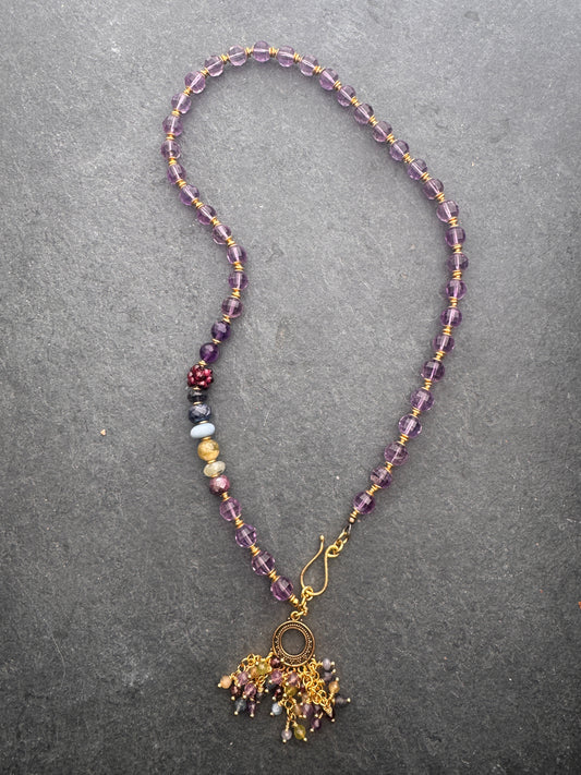 Amethyst faceted gemstone, iolite, green garnet, garnet, prehnite, peridot, aquamarine, blue opal and brass metal, necklace.