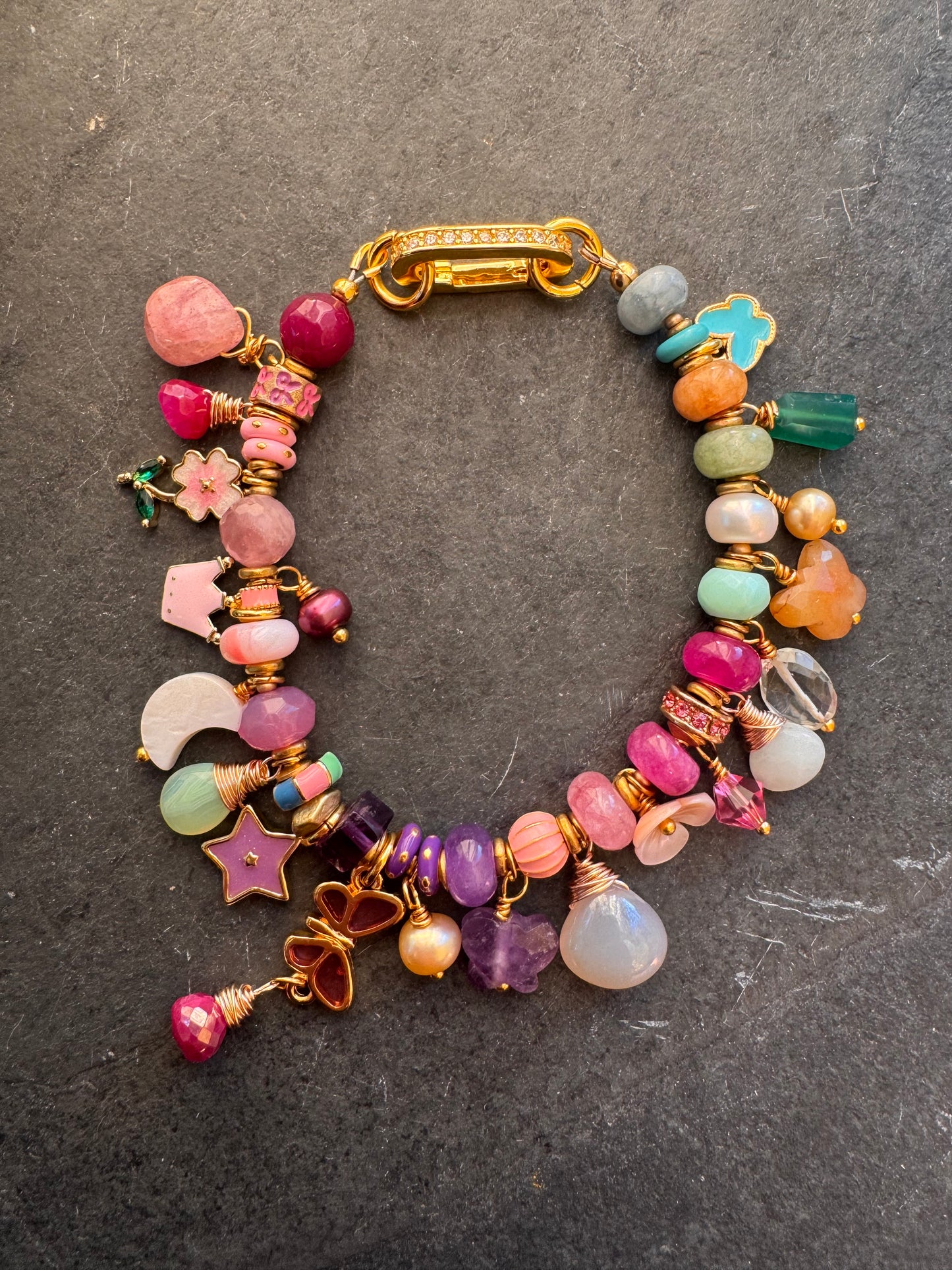 Flower mixed charm bracelet. Mixed stones, pearls and charms, gold metal bracelet.