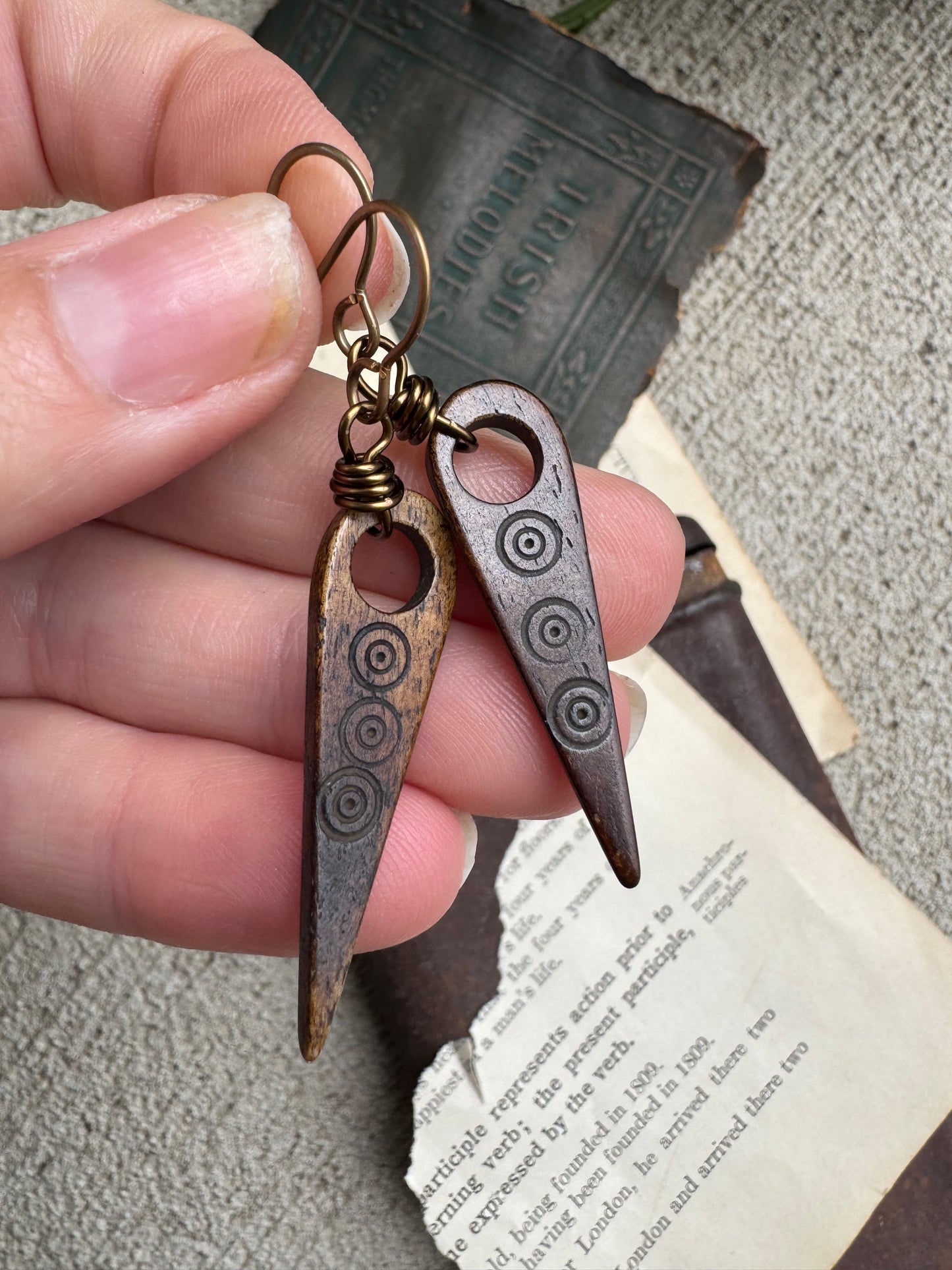 Bone beads, bronze metal earrings.