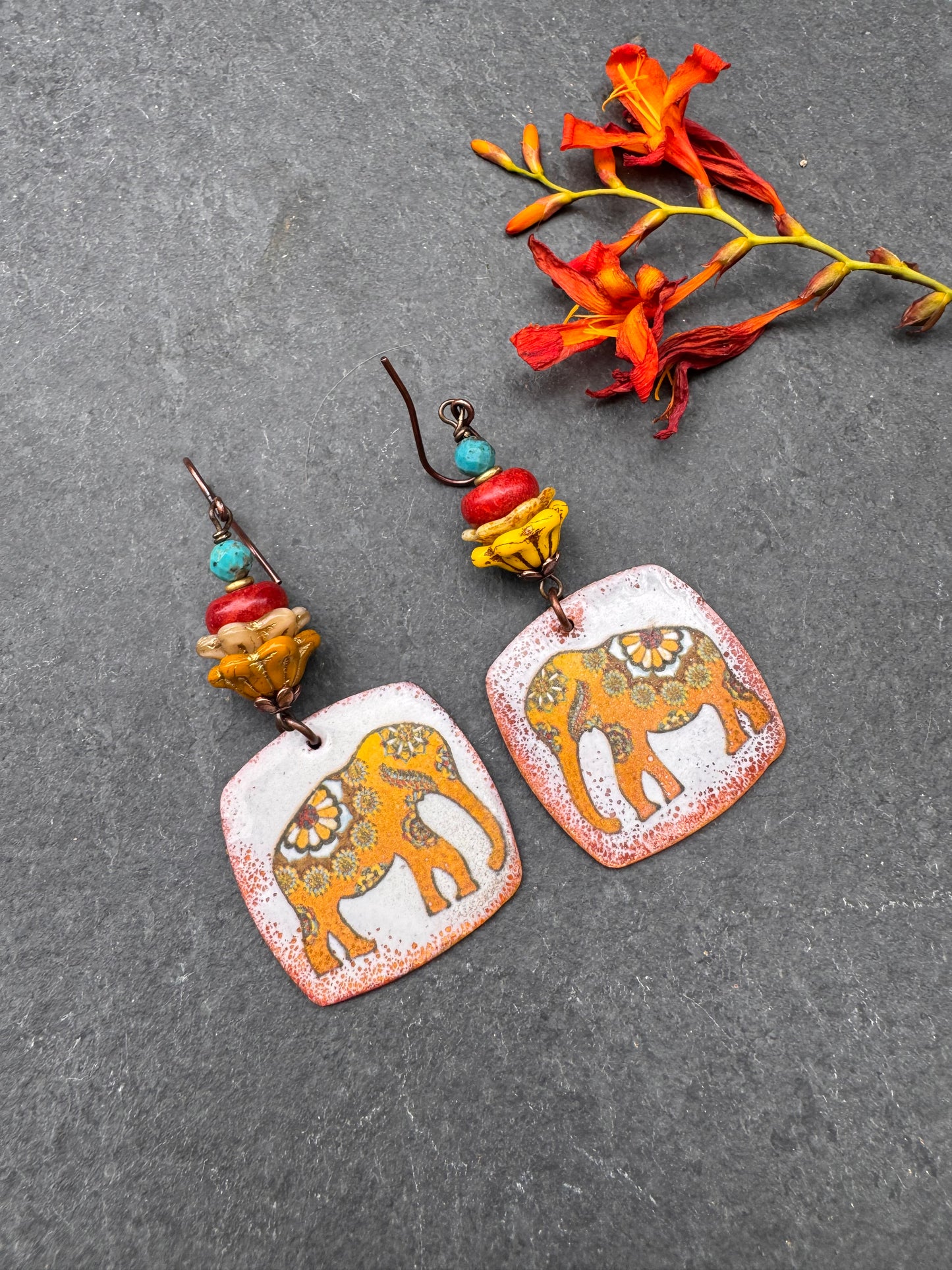 Elephant enameled metal charms, glass flower beads, red coral, turquoise and copper metal, earrings
