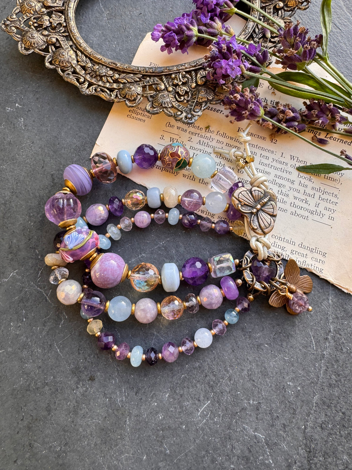 Handmade lampwork glass, 
Amethyst, citrine, aquamarine, faceted green amethyst, fluorite stone, purple oyster, and bronze  butterfly metal button.