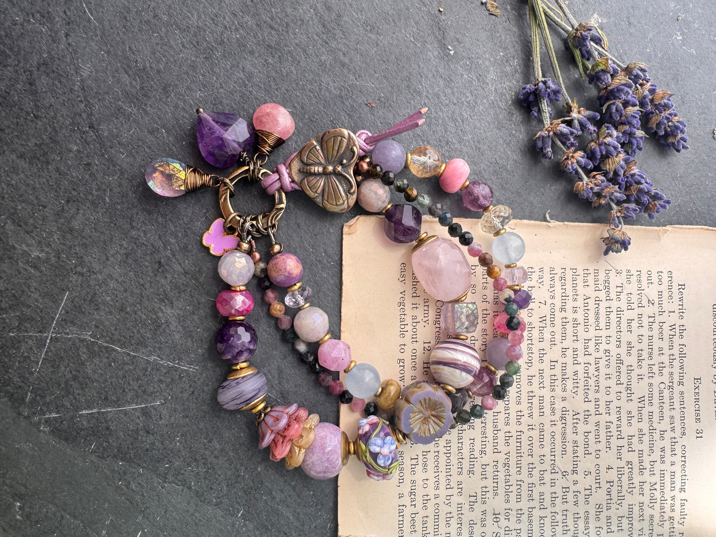 Handmade lampwork glass, mixed gemstone, ceramic, Czech Glass and butterfly button button. Purple leather closure.