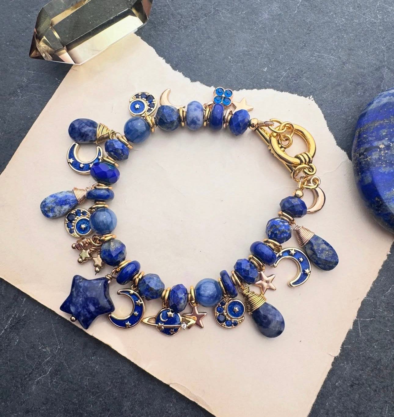 Space charm bracelet. Lapis lazuli, sodalite, charms and gold metal bracelet.