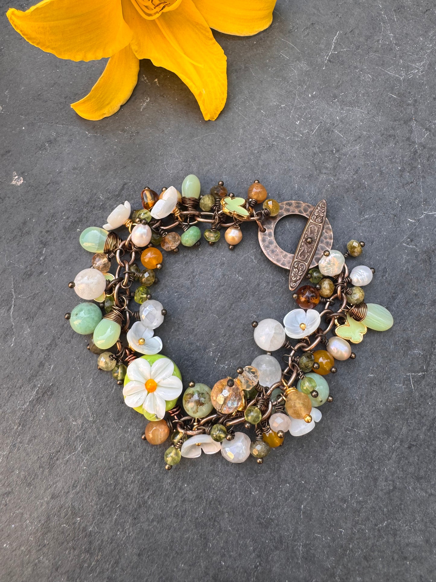 Daisy. Handmade lampwork glass, Mixed gemstone, pearls, bronze metal, charm bracelet.