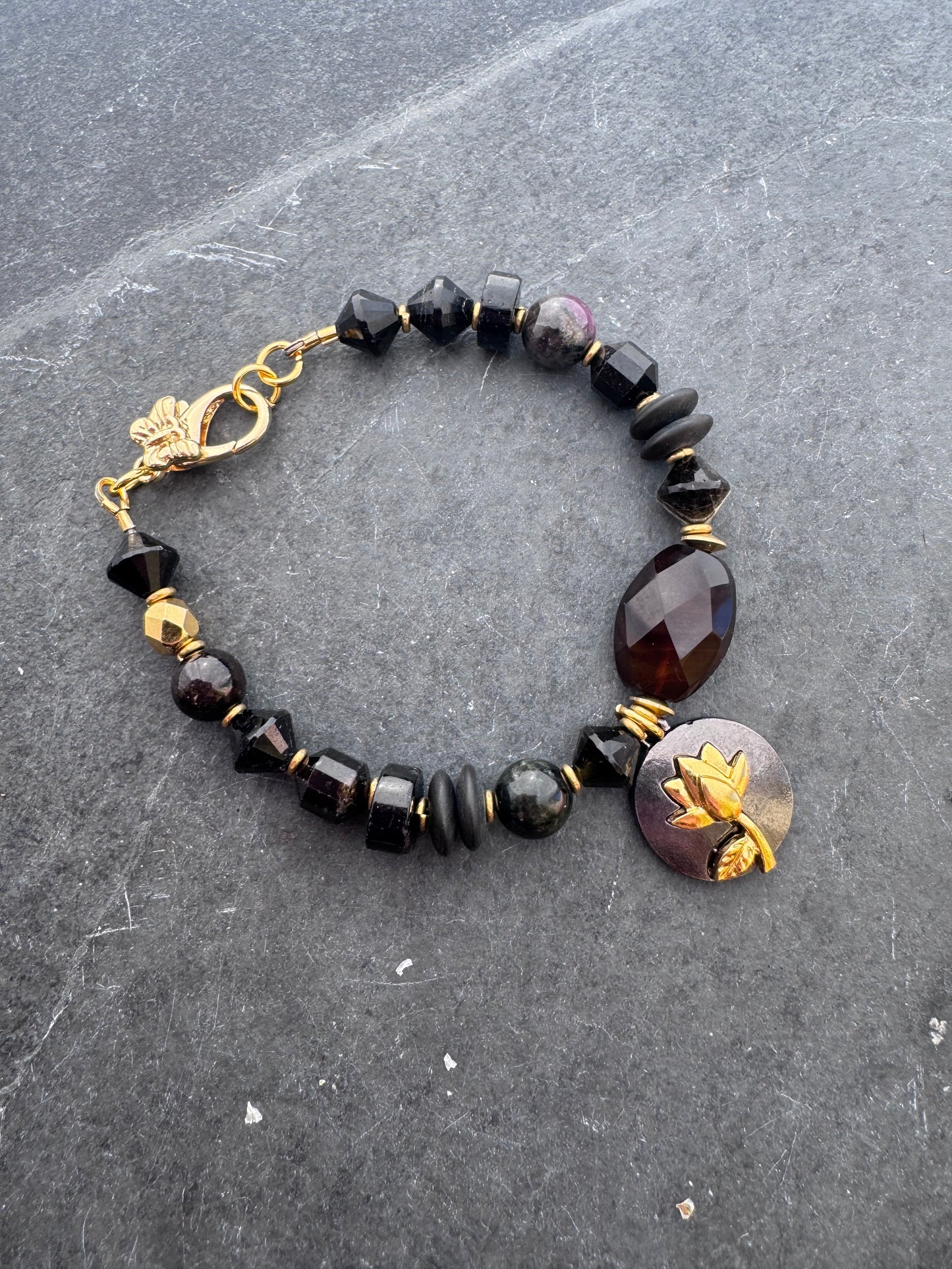 Black tourmaline, agate, black onyx stone, gold metal bracelet.