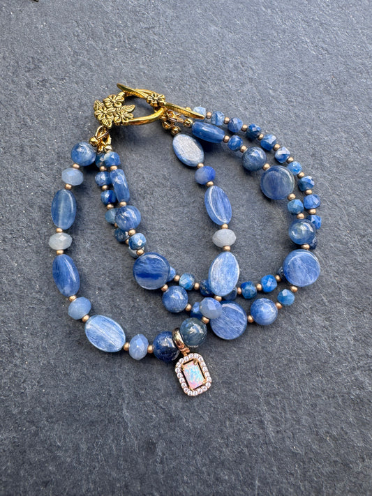 Kyanite gemstone and gold metal bracelet.