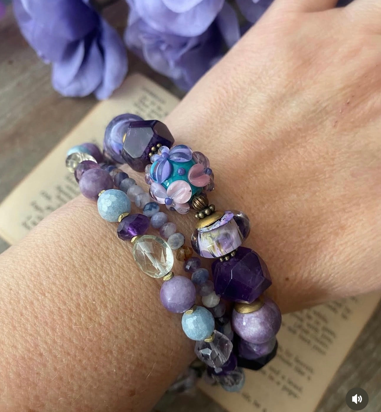 lampwork glass, 
Purple Stichtite, aquamarine, faceted green amethyst, fluorite stone, purple oyster, and bronze butterfly metal button.