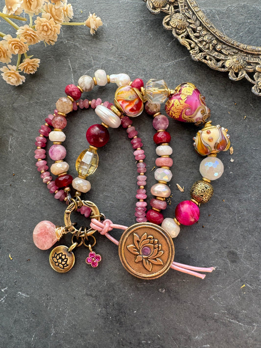 Ruby. handmade lampwork glass, moonstone, strawberry quartz, ruby, pink tourmaline, topaz, pearls, lotus flower button, pink leather, bracelet