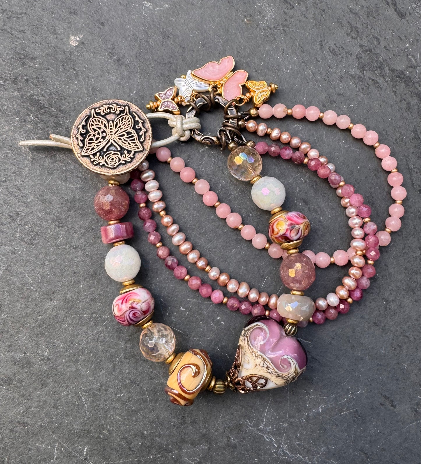Pink opal, pink Tourmaline, moonstone mystic, strawberry quartz mystic, citrine mystic, pink pearls and handmade lamp work glass, bronze butterfly button, white leather.