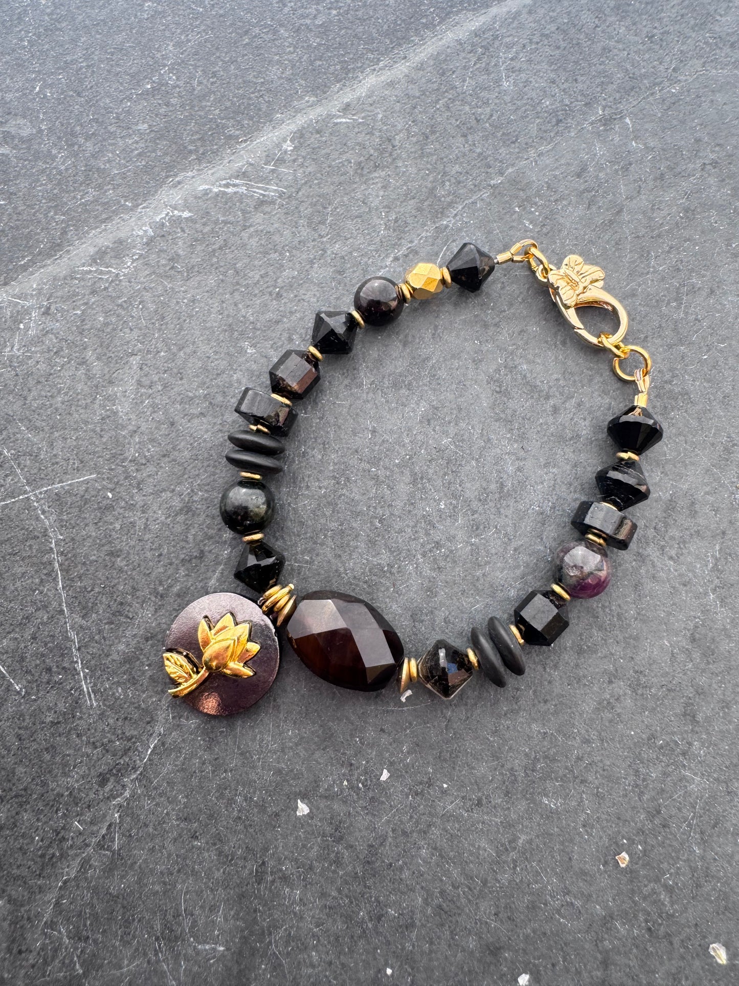 Black tourmaline, agate, black onyx stone, gold metal bracelet.