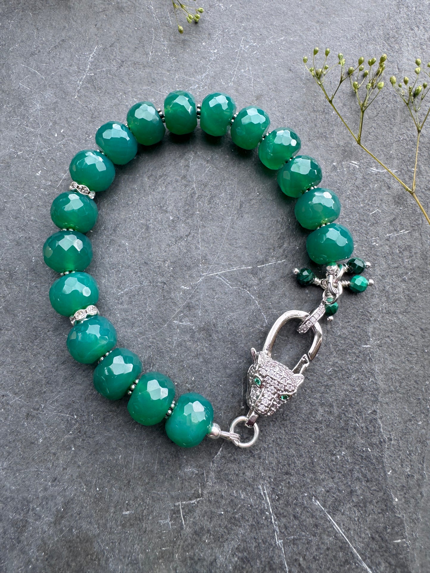Green onyx faceted stone, jaguar silver rhinestone clasp.